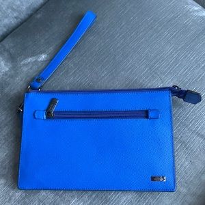 Bright blue Tumi wristlet with two sections and 4 card slots